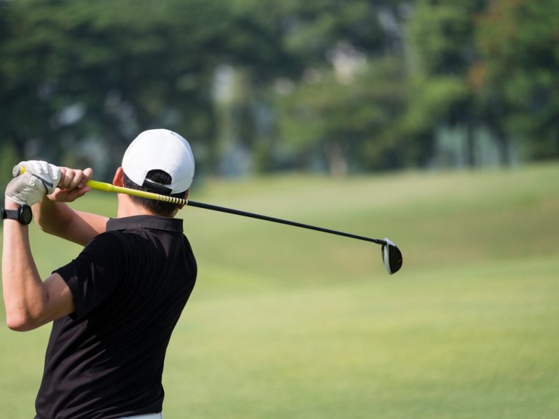 Golfer perfecting his swing on the course.